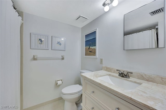 bathroom with vanity, tile patterned flooring, toilet, and walk in shower