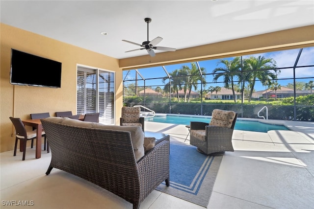 view of patio / terrace with ceiling fan, an outdoor living space, and glass enclosure