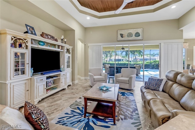 living room featuring wood ceiling and a tray ceiling