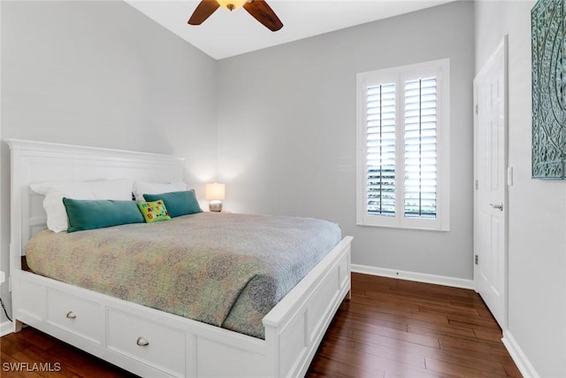 bedroom featuring ceiling fan, dark hardwood / wood-style floors, and multiple windows