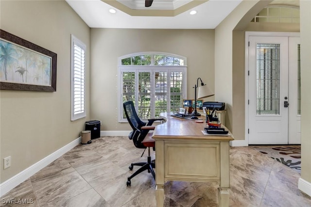 office featuring a tray ceiling and crown molding