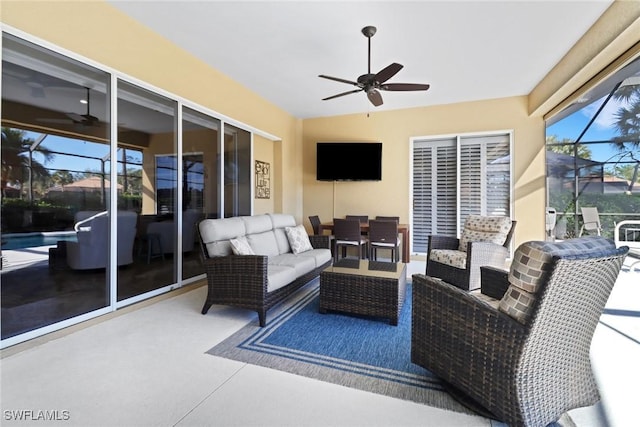 view of patio with ceiling fan, glass enclosure, and outdoor lounge area