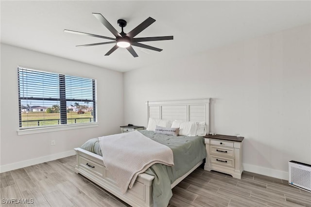 bedroom featuring light wood-type flooring and ceiling fan