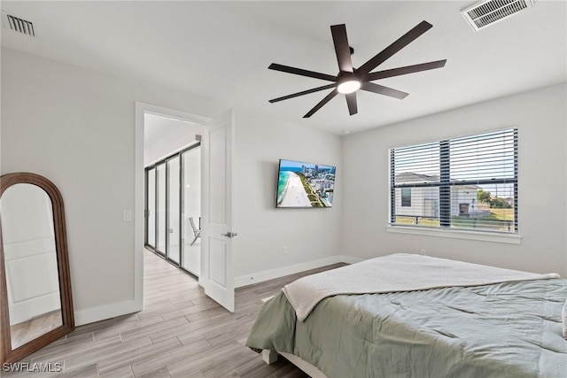 bedroom with light wood-type flooring and ceiling fan