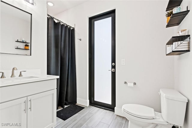 bathroom featuring vanity and toilet