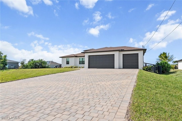 view of front facade with a garage and a front lawn