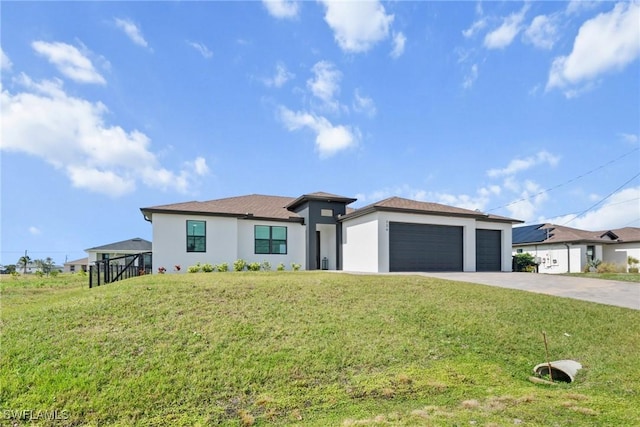 view of front facade with a garage and a front lawn