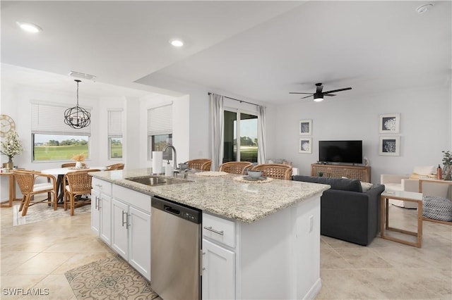 kitchen featuring decorative light fixtures, dishwasher, sink, white cabinetry, and an island with sink