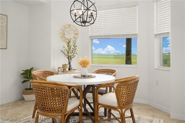 tiled dining room with a notable chandelier