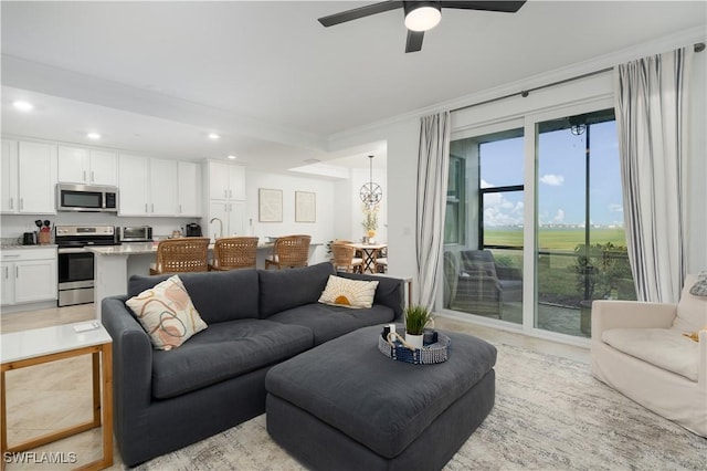 tiled living room featuring ceiling fan and ornamental molding