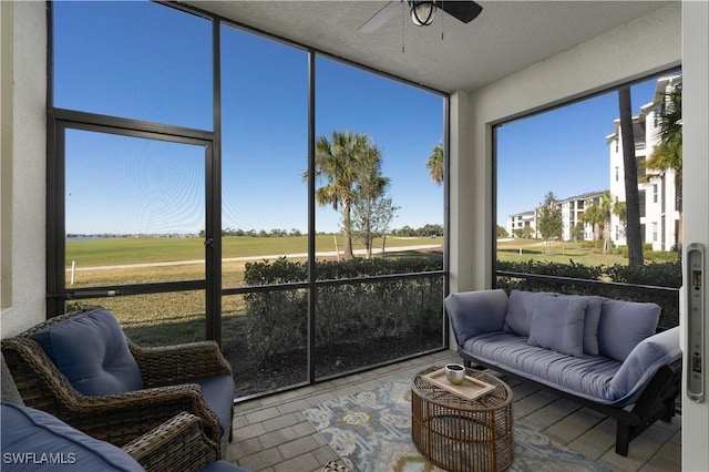 sunroom featuring ceiling fan