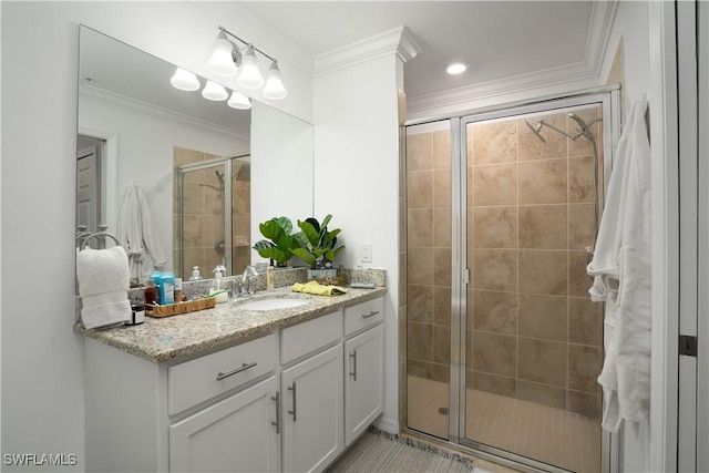 bathroom featuring walk in shower, vanity, and ornamental molding