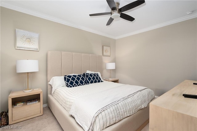 carpeted bedroom with ceiling fan and ornamental molding