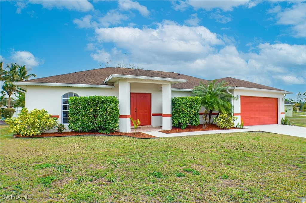 view of front facade with a front lawn and a garage