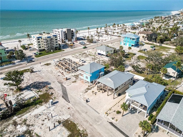 bird's eye view featuring a water view and a beach view