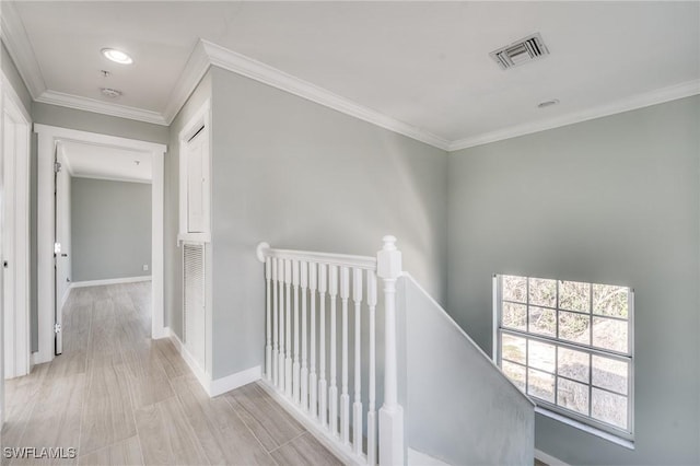 hall featuring crown molding and light hardwood / wood-style flooring