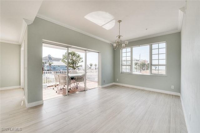 unfurnished dining area with a notable chandelier, crown molding, and light wood-type flooring