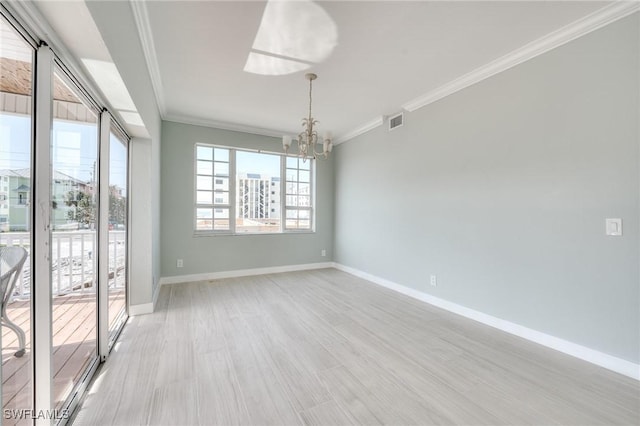 empty room featuring a notable chandelier, crown molding, and light hardwood / wood-style floors