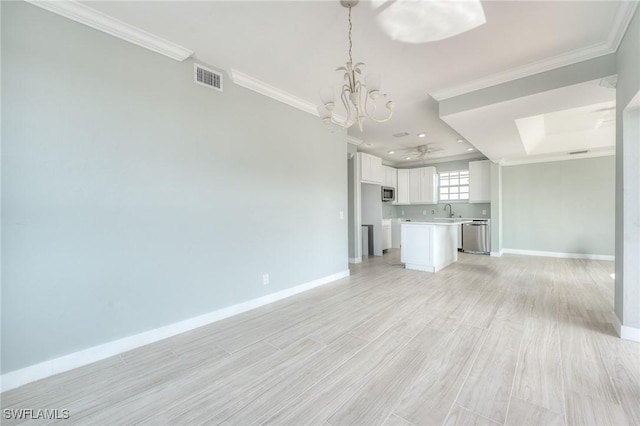 unfurnished living room featuring sink, ornamental molding, light hardwood / wood-style floors, and a chandelier