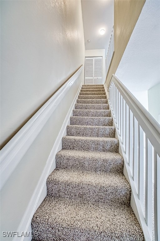 stairway featuring baseboards