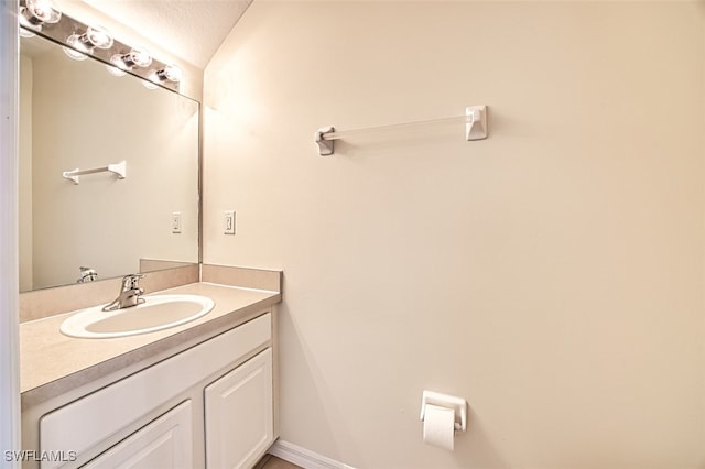 bathroom with vanity and baseboards