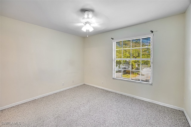 unfurnished room featuring baseboards