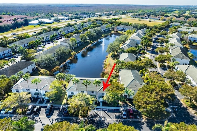 birds eye view of property with a water view and a residential view