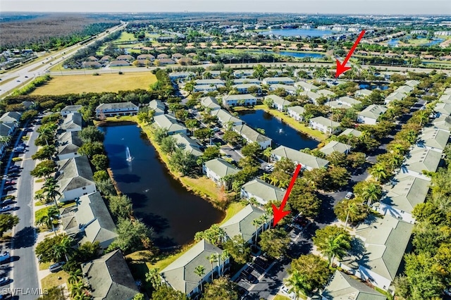 bird's eye view with a water view and a residential view