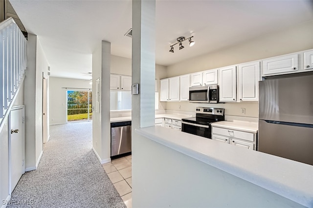 kitchen featuring light tile patterned floors, white cabinetry, baseboards, light countertops, and appliances with stainless steel finishes