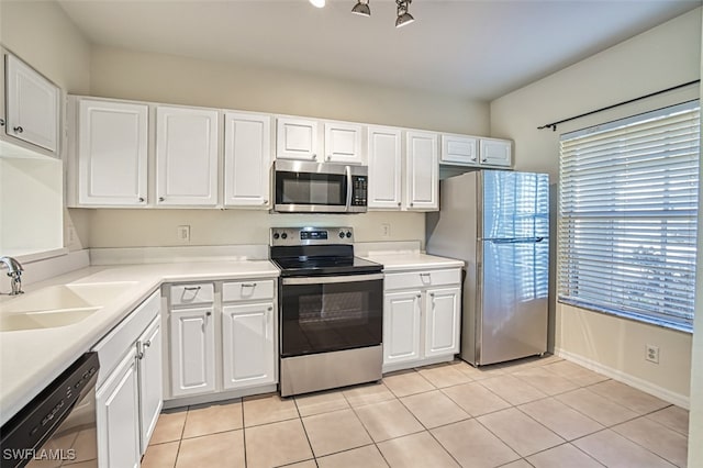 kitchen with white cabinetry, appliances with stainless steel finishes, light countertops, and light tile patterned flooring