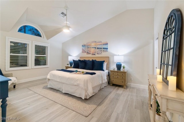 bedroom with ceiling fan, lofted ceiling, and light hardwood / wood-style flooring