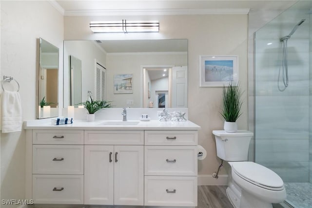 bathroom featuring toilet, a shower with shower door, crown molding, vanity, and hardwood / wood-style floors