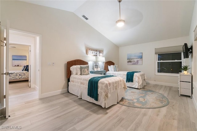 bedroom with ceiling fan, lofted ceiling, and light hardwood / wood-style floors