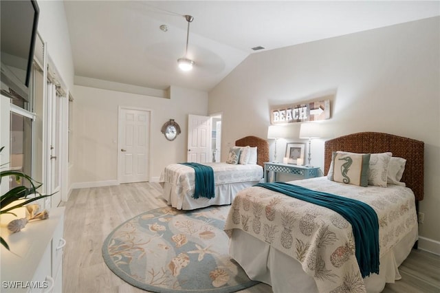 bedroom with lofted ceiling and light wood-type flooring