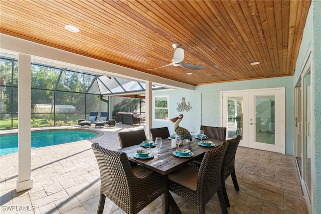 sunroom / solarium with a pool, wood ceiling, french doors, and ceiling fan