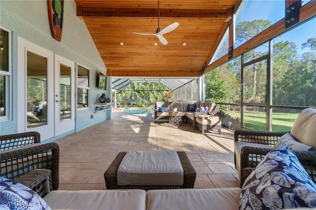 sunroom / solarium featuring ceiling fan, vaulted ceiling, and wooden ceiling