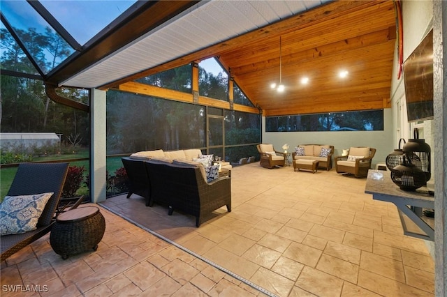 patio terrace at dusk featuring an outdoor hangout area and a lanai