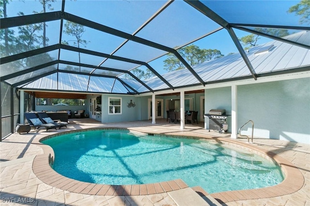 view of swimming pool featuring a lanai, outdoor lounge area, grilling area, and a patio area