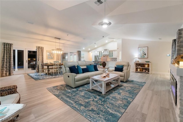 living room with lofted ceiling and light hardwood / wood-style floors