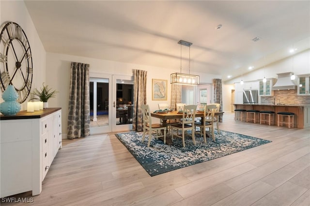 dining space featuring light hardwood / wood-style flooring and french doors