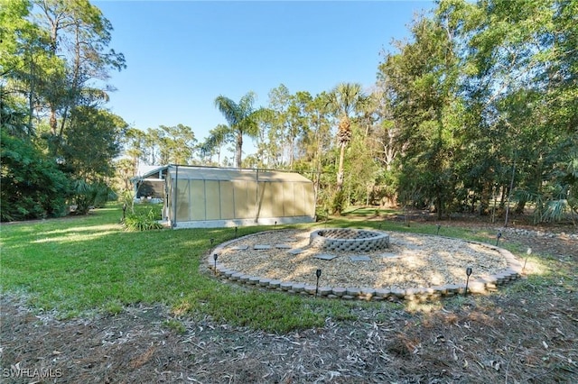 view of yard with an outbuilding and a fire pit