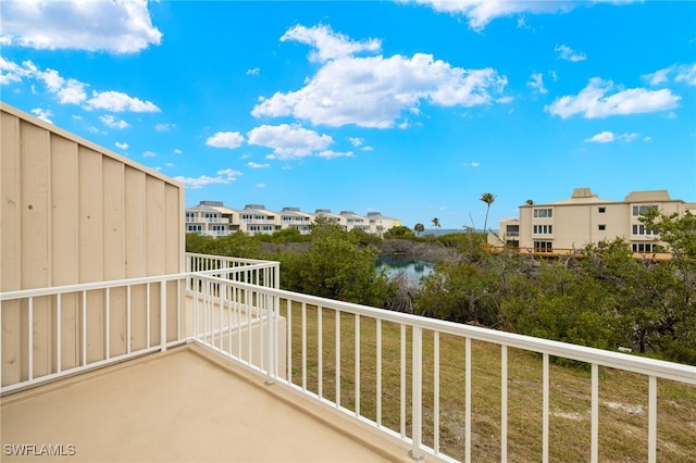 balcony featuring a residential view and a water view