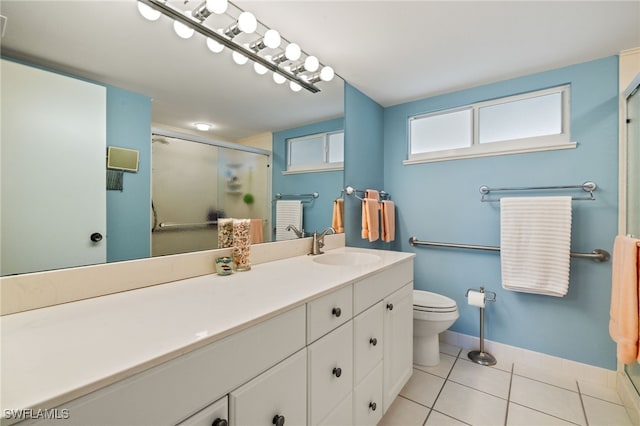 full bathroom with toilet, vanity, baseboards, tile patterned floors, and a stall shower