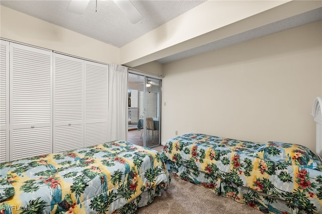 carpeted bedroom with a closet, ceiling fan, and a textured ceiling