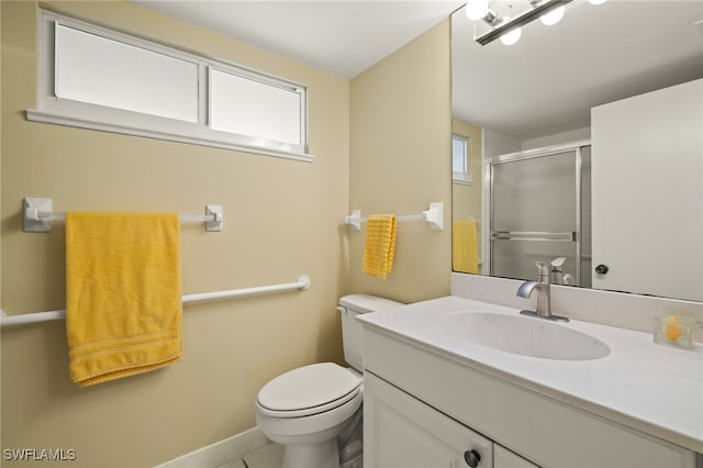 full bathroom featuring a wealth of natural light, a shower stall, toilet, and vanity