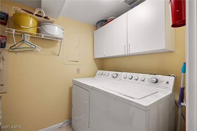 clothes washing area with cabinet space, baseboards, visible vents, and washer and dryer