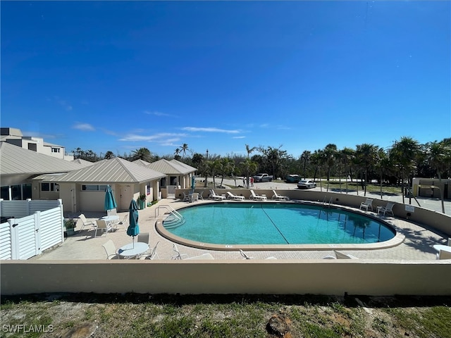 pool featuring a patio area and fence