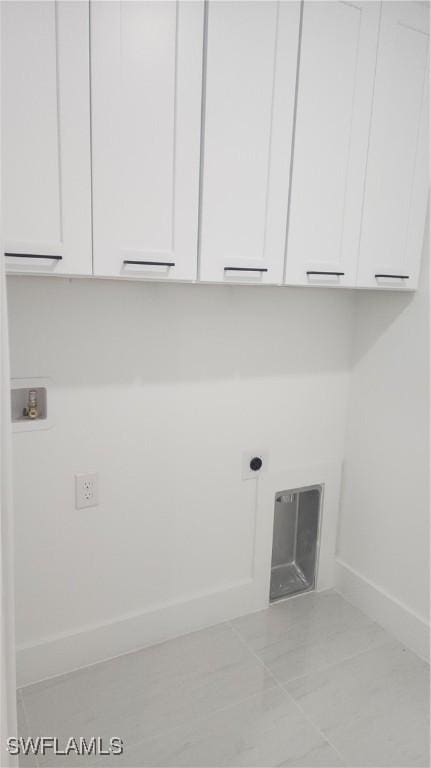 clothes washing area with hookup for a washing machine, electric dryer hookup, light tile patterned floors, and cabinets