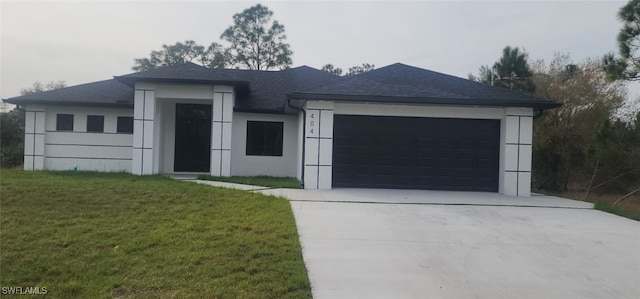 view of front of home with a garage and a front yard