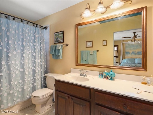 bathroom with tile patterned floors, toilet, vanity, curtained shower, and ceiling fan